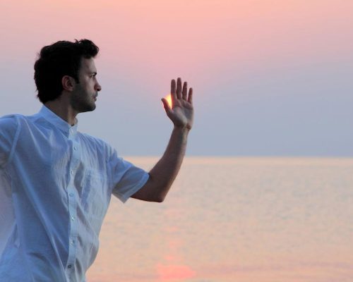 Practicing Tai Chi Chuan peacefully on the beach